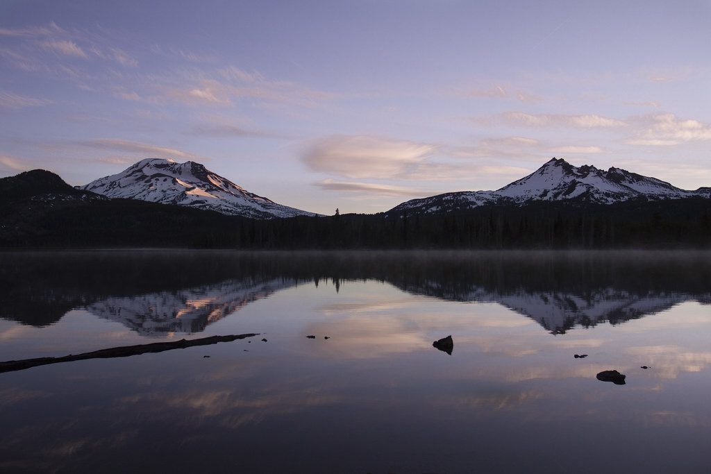 Still mountain lake reflecting the sky at dawn